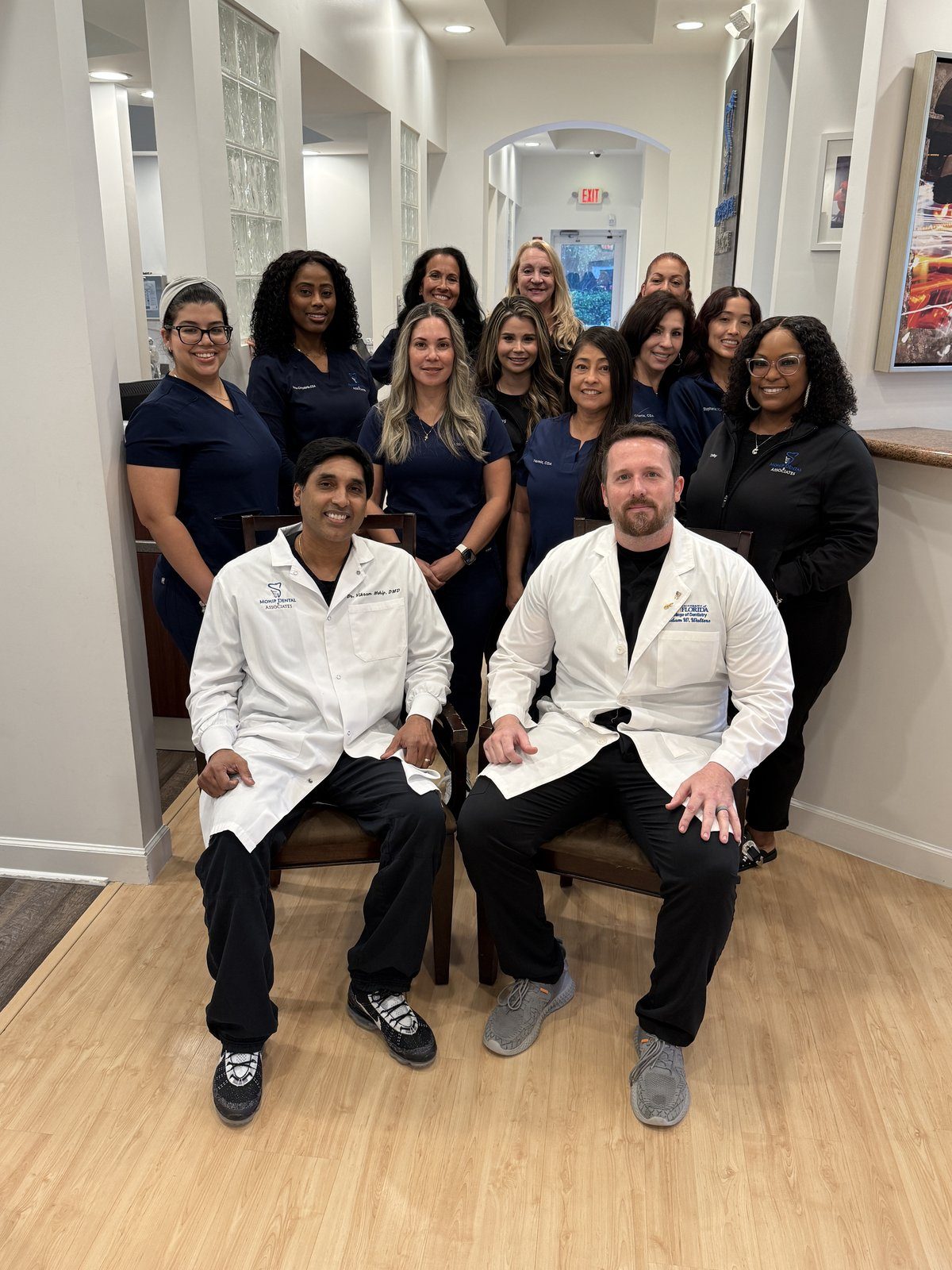 Friendly Team Of Dental Professionals At Mohip Dental And Associates In Wellington Fl, Gathered In The Office For A Staff Photo.